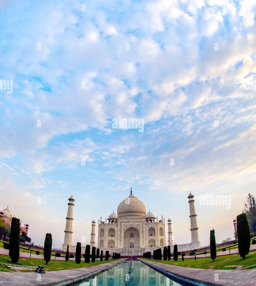 Experience the serene view from an airplane window overlooking a sunset sky and ocean horizon.